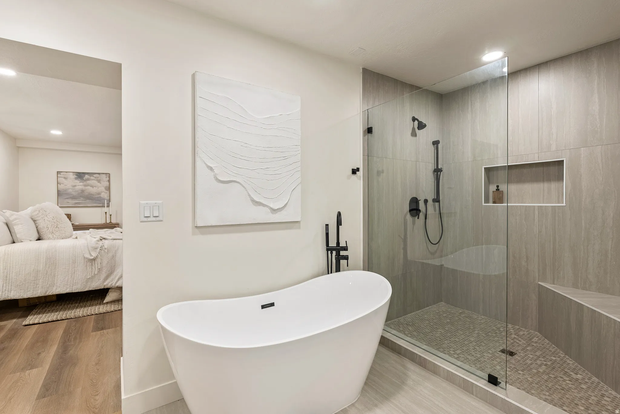 Full bathroom featuring walk in shower, recessed lighting, wood finished floors, and a freestanding bath