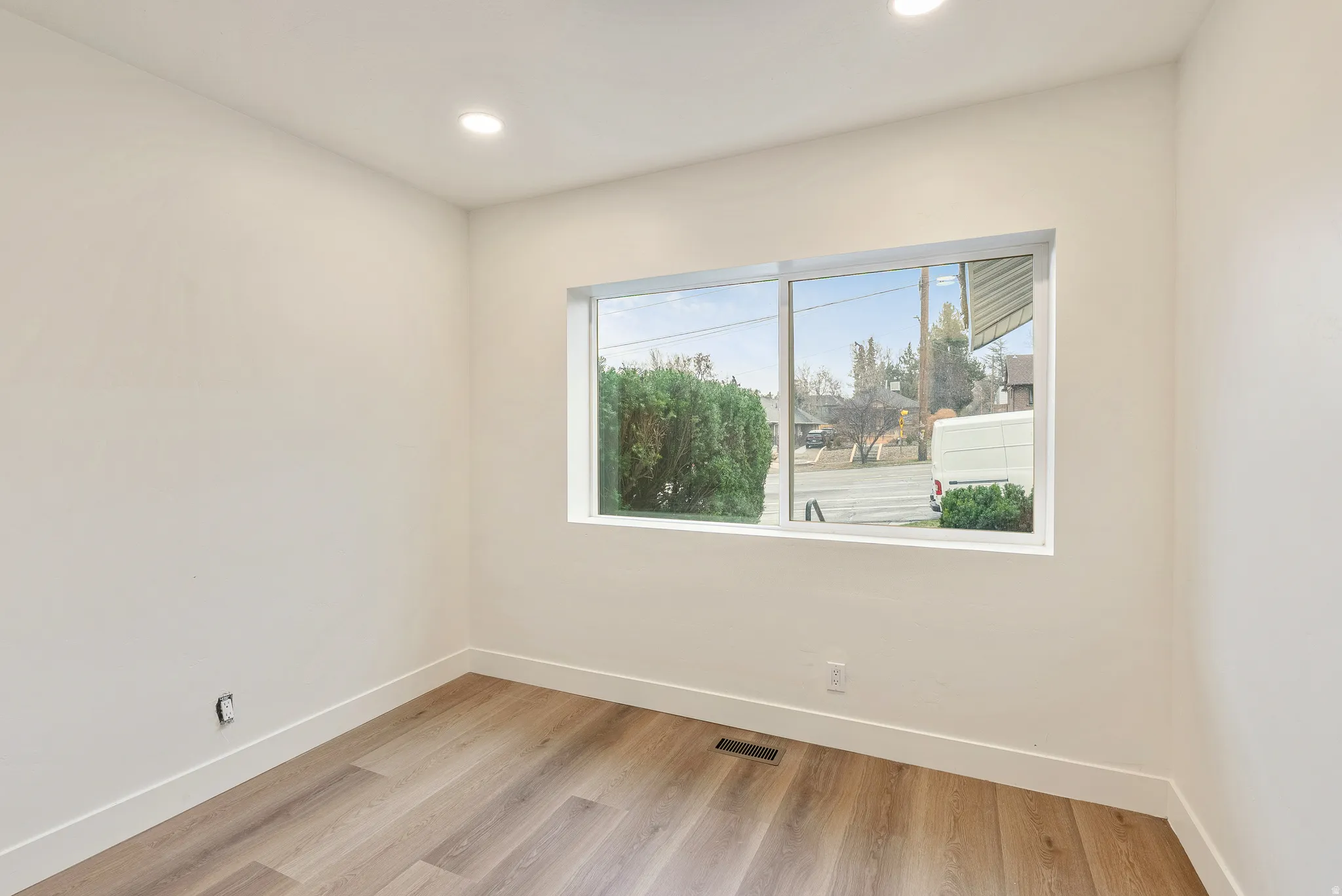 Unfurnished room featuring light wood finished floors and recessed lighting
