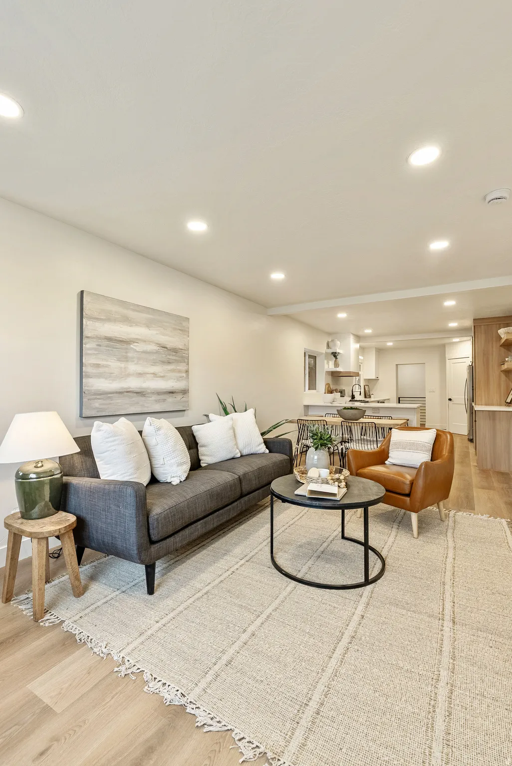 Living area with light wood-style flooring and recessed lighting