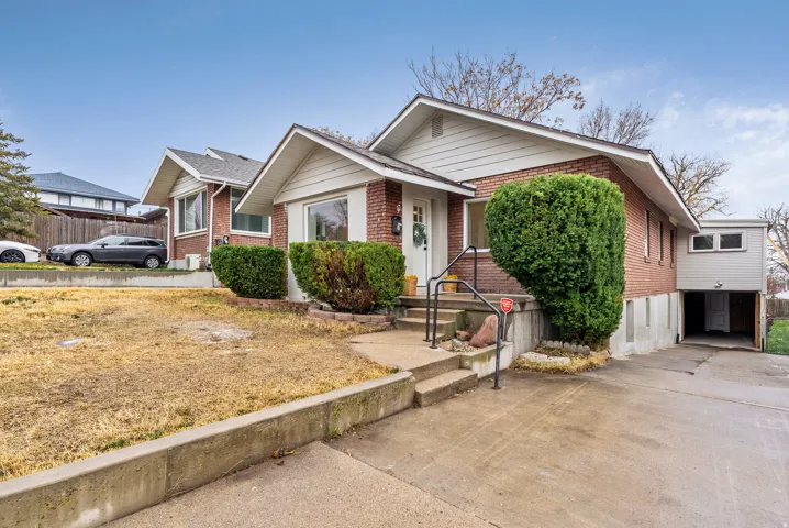 View of front of home with concrete driveway and brick siding