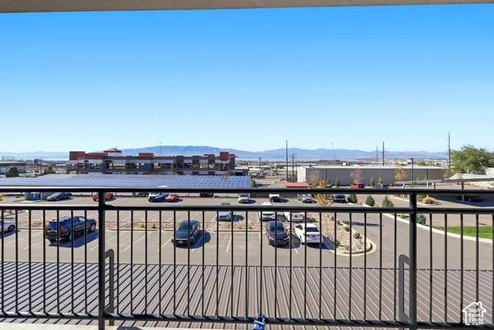 Elevated covered balcony with black metal railing and expansive mountain backdrop
