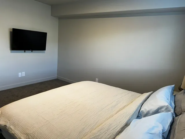 Bedroom with carpet flooring and baseboards