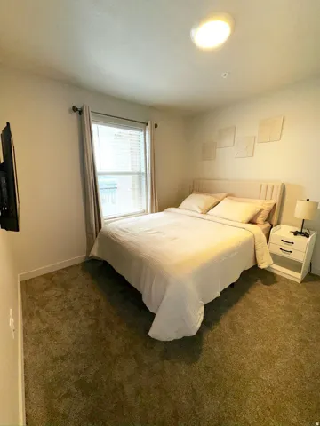 Carpeted bedroom with baseboards