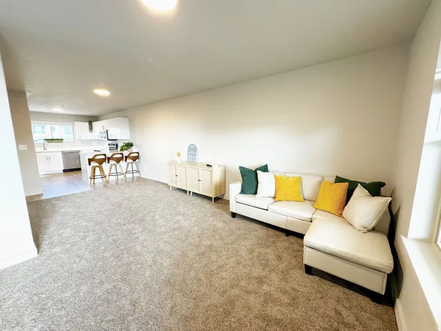 Living room featuring light colored carpet and recessed lighting