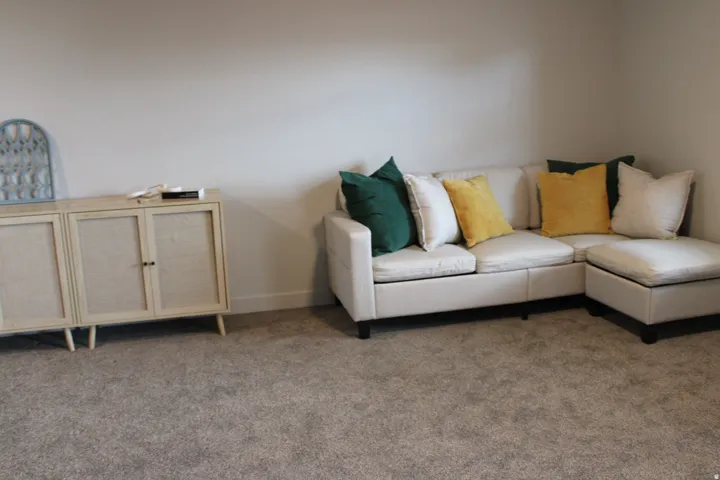 Carpeted living room featuring baseboards