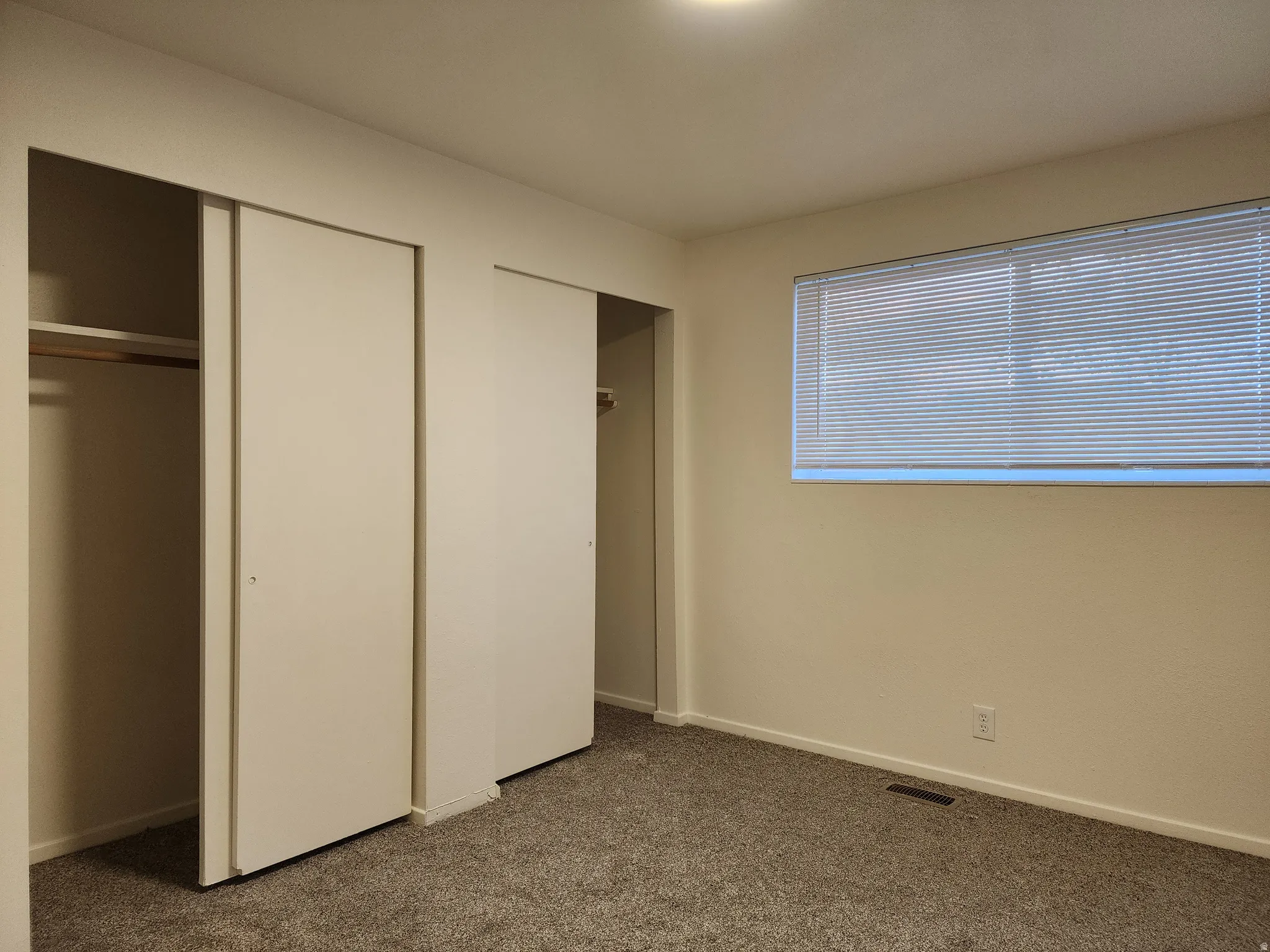 Typical bedroom with carpet flooring and good size closet
