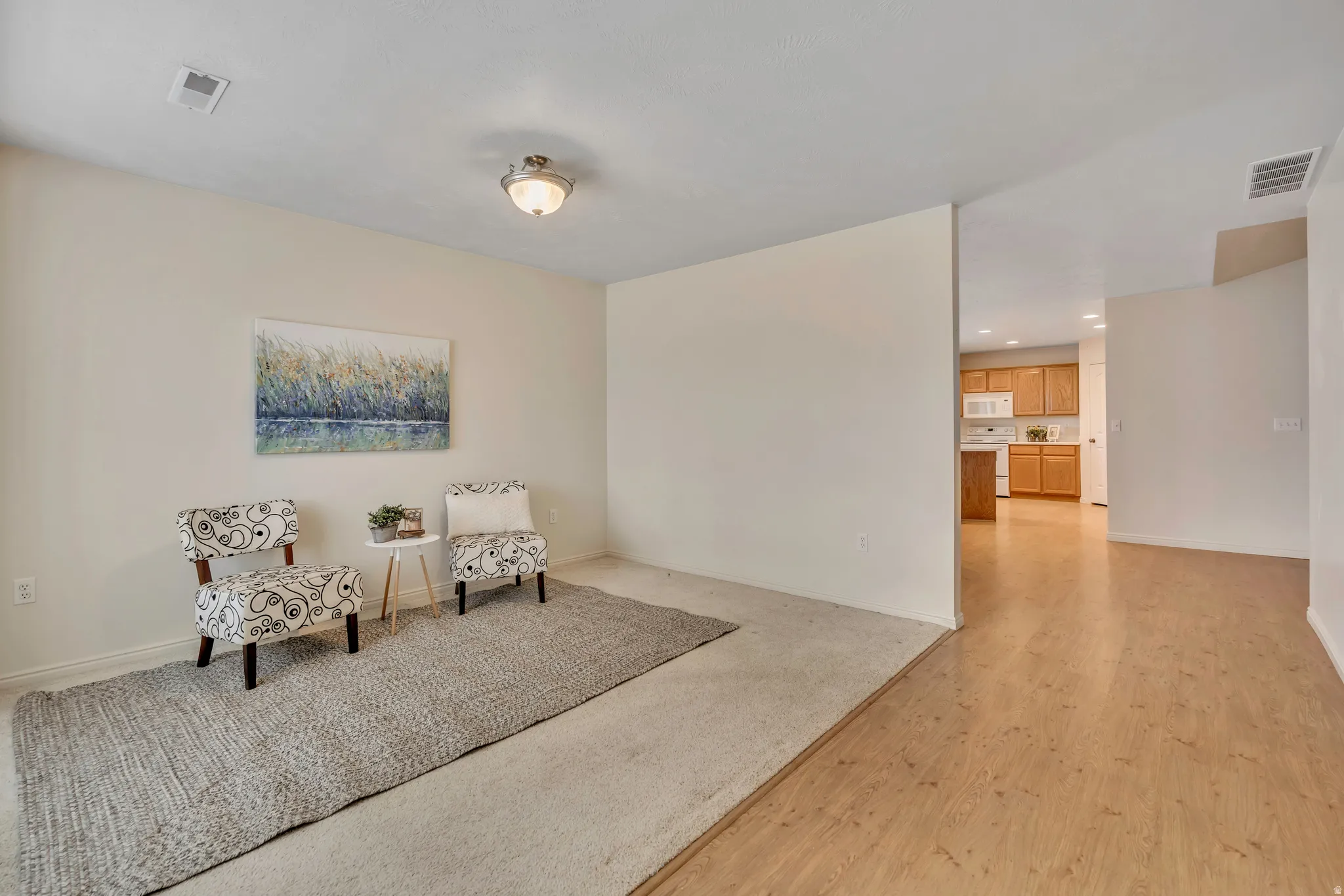 Sitting room featuring light wood-style flooring and recessed lighting