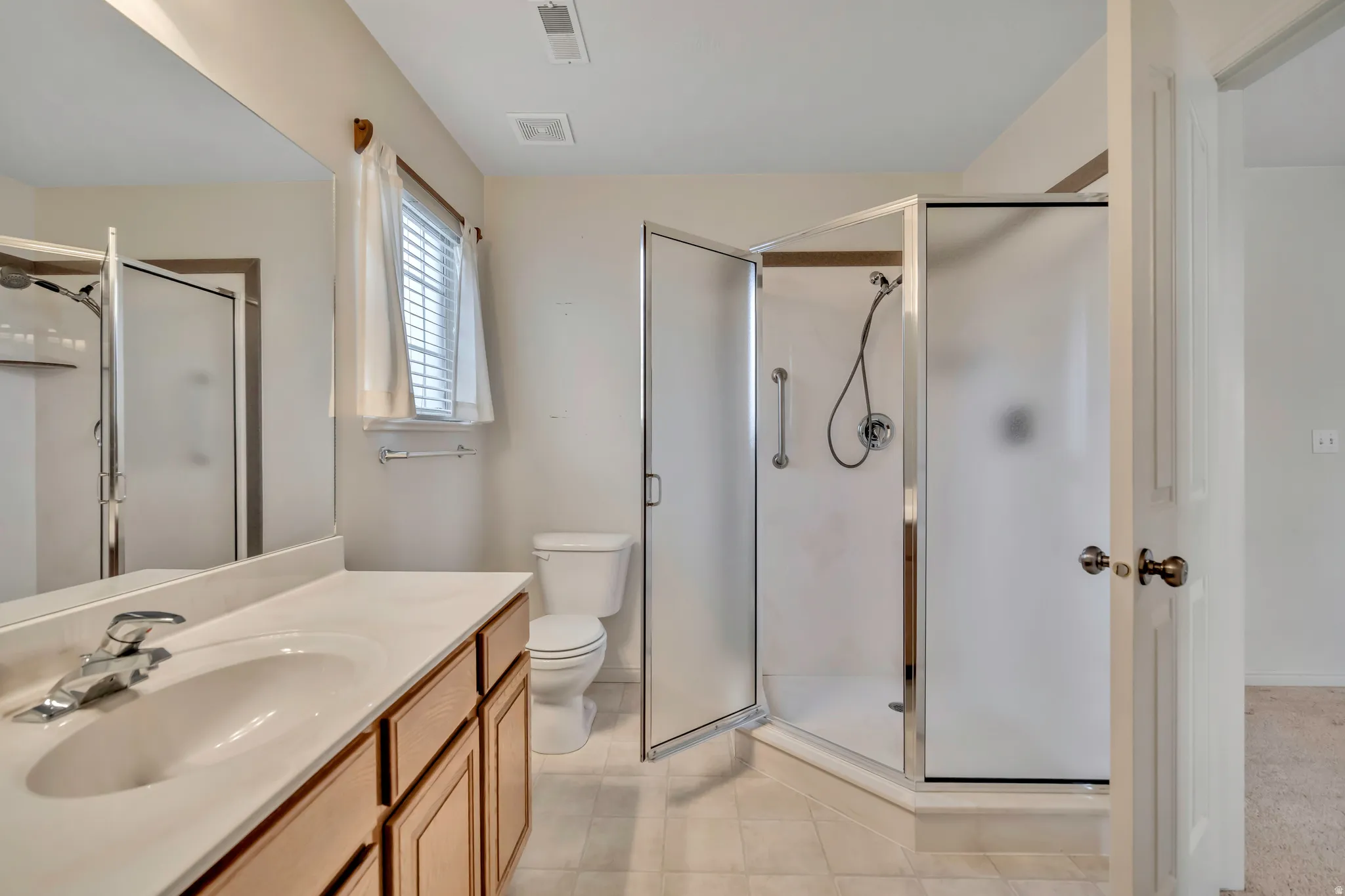 Bathroom with vanity and a shower stall