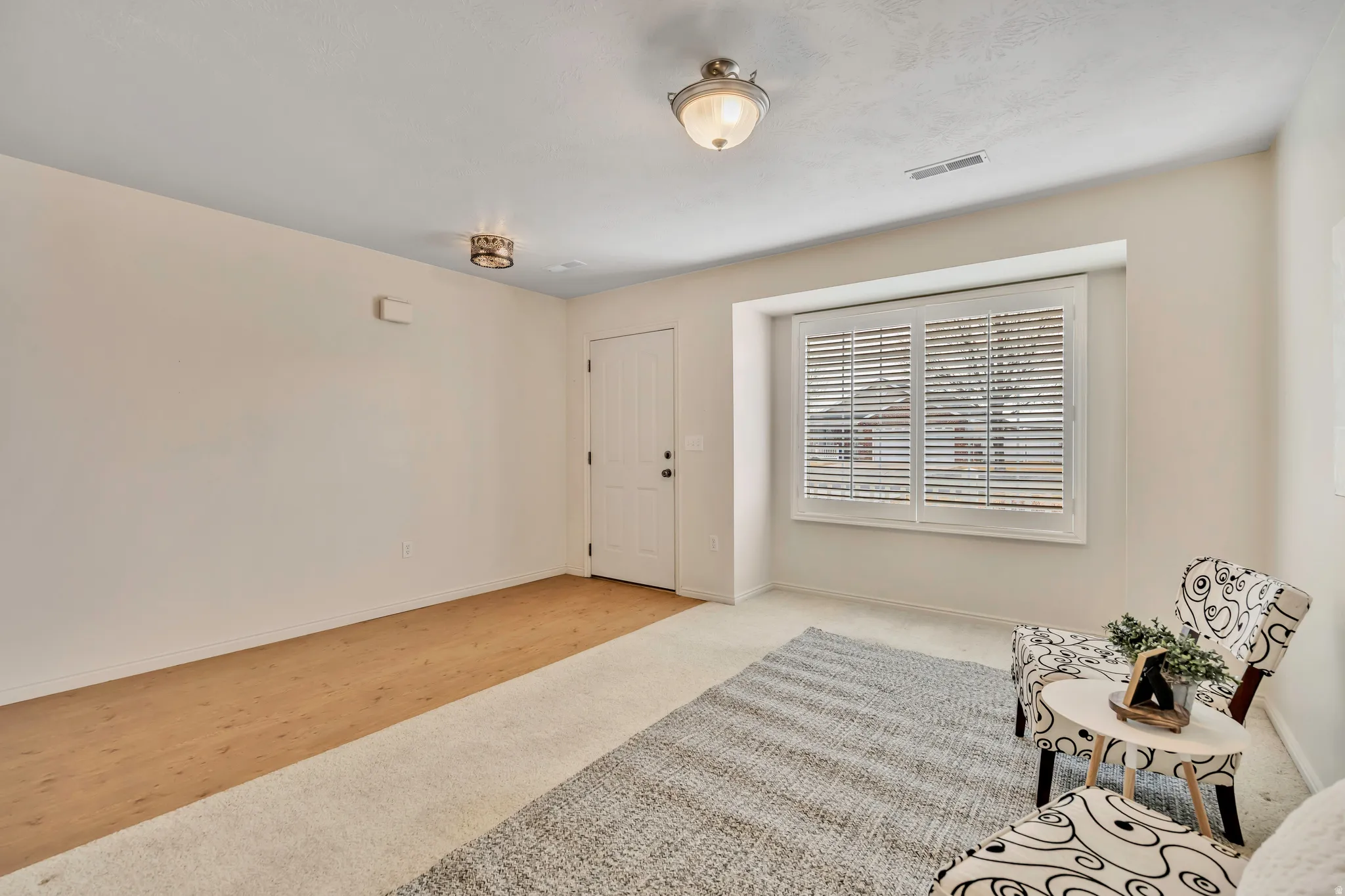 Sitting room with carpet and baseboards