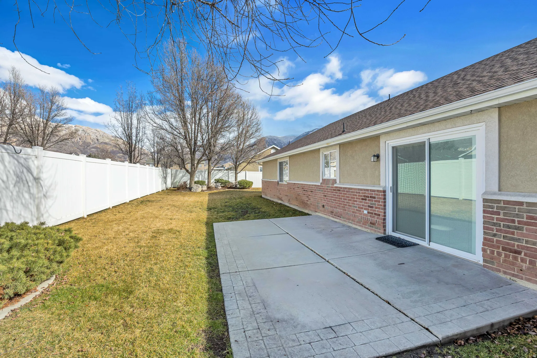 Fenced yard featuring a patio area and a mountain view