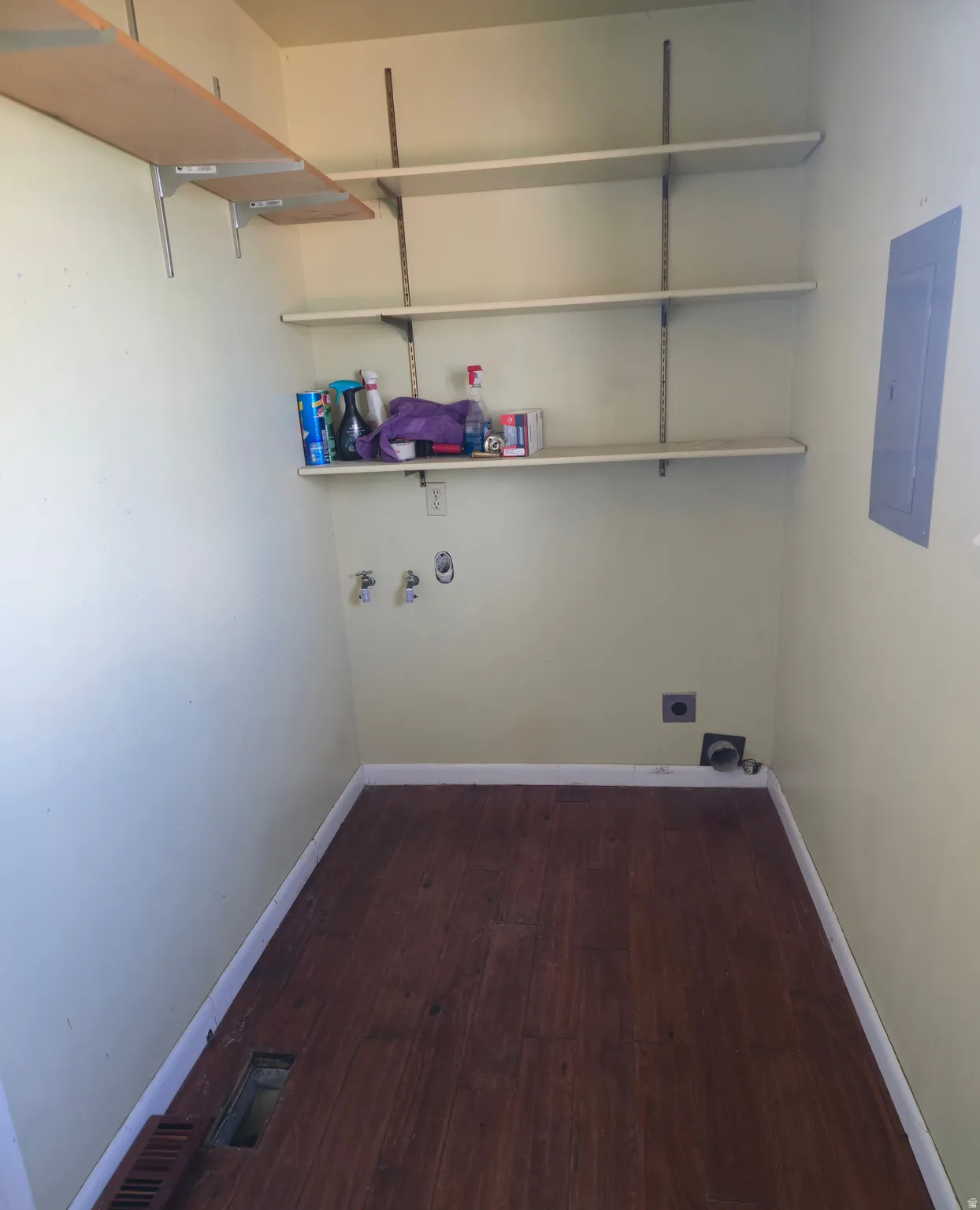 Laundry room featuring dark wood-type flooring, electric panel, washer hookup, and electric dryer hookup