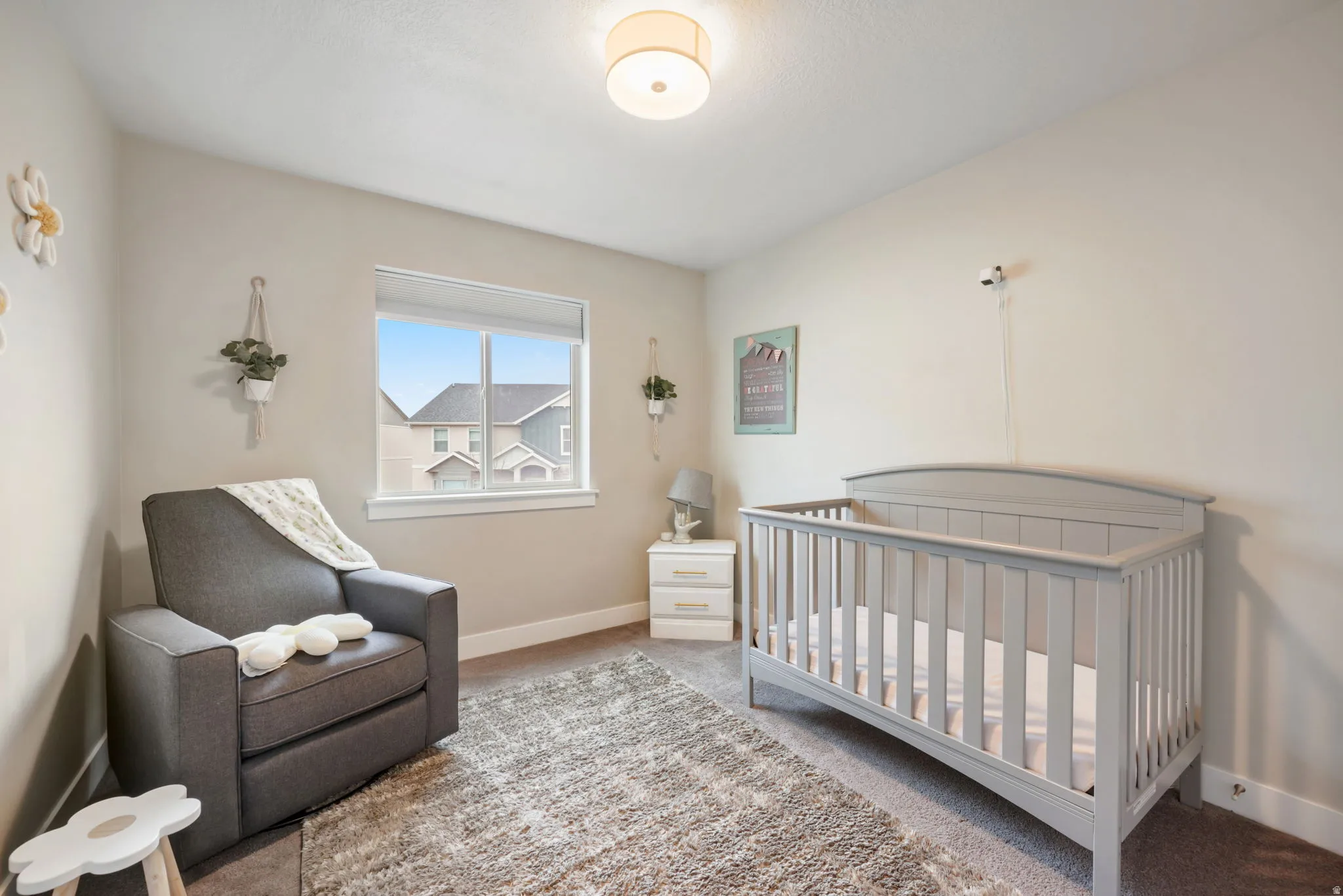 Bedroom with a crib and carpet floors
