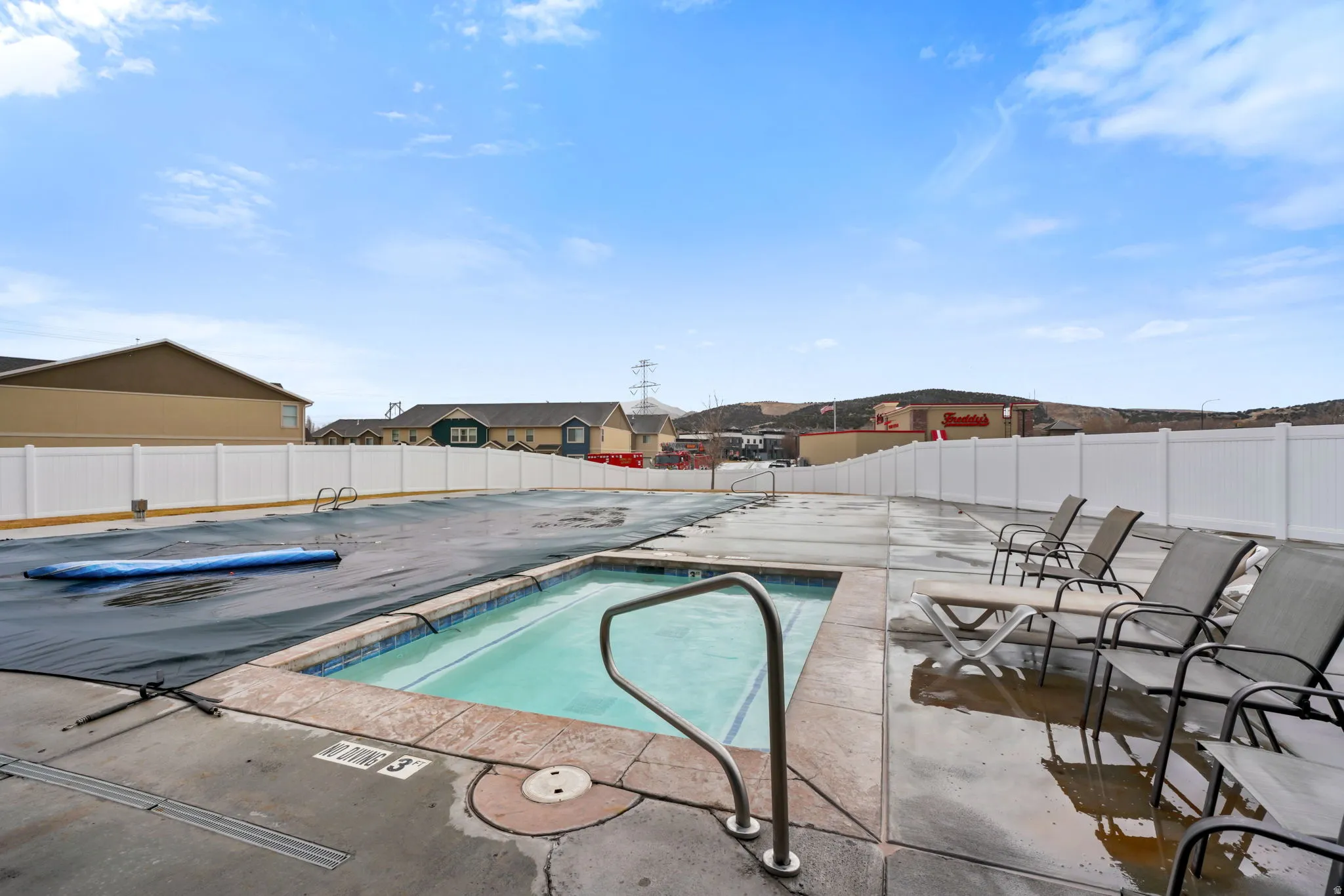 Community pool with a patio