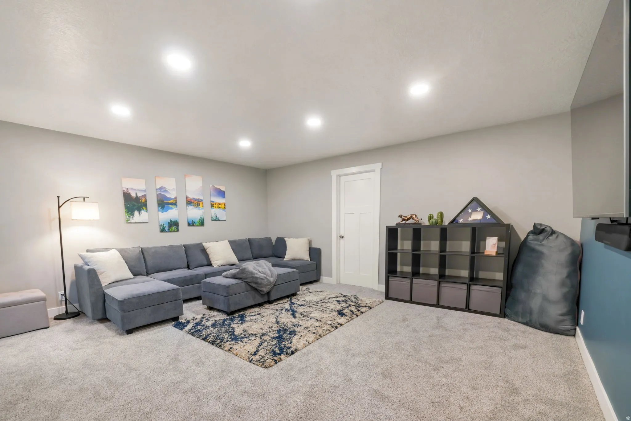Carpeted living room with recessed lighting