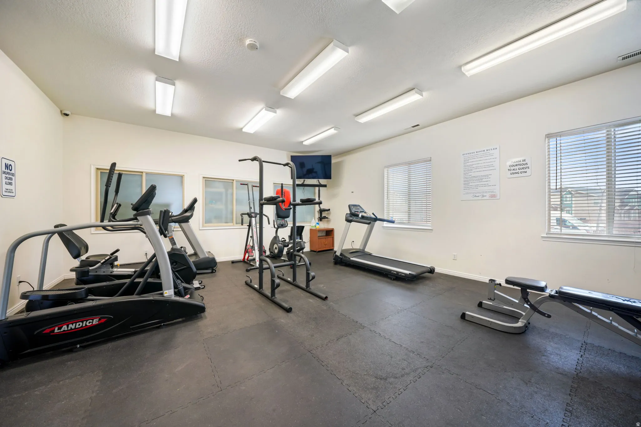 Exercise room with a textured ceiling