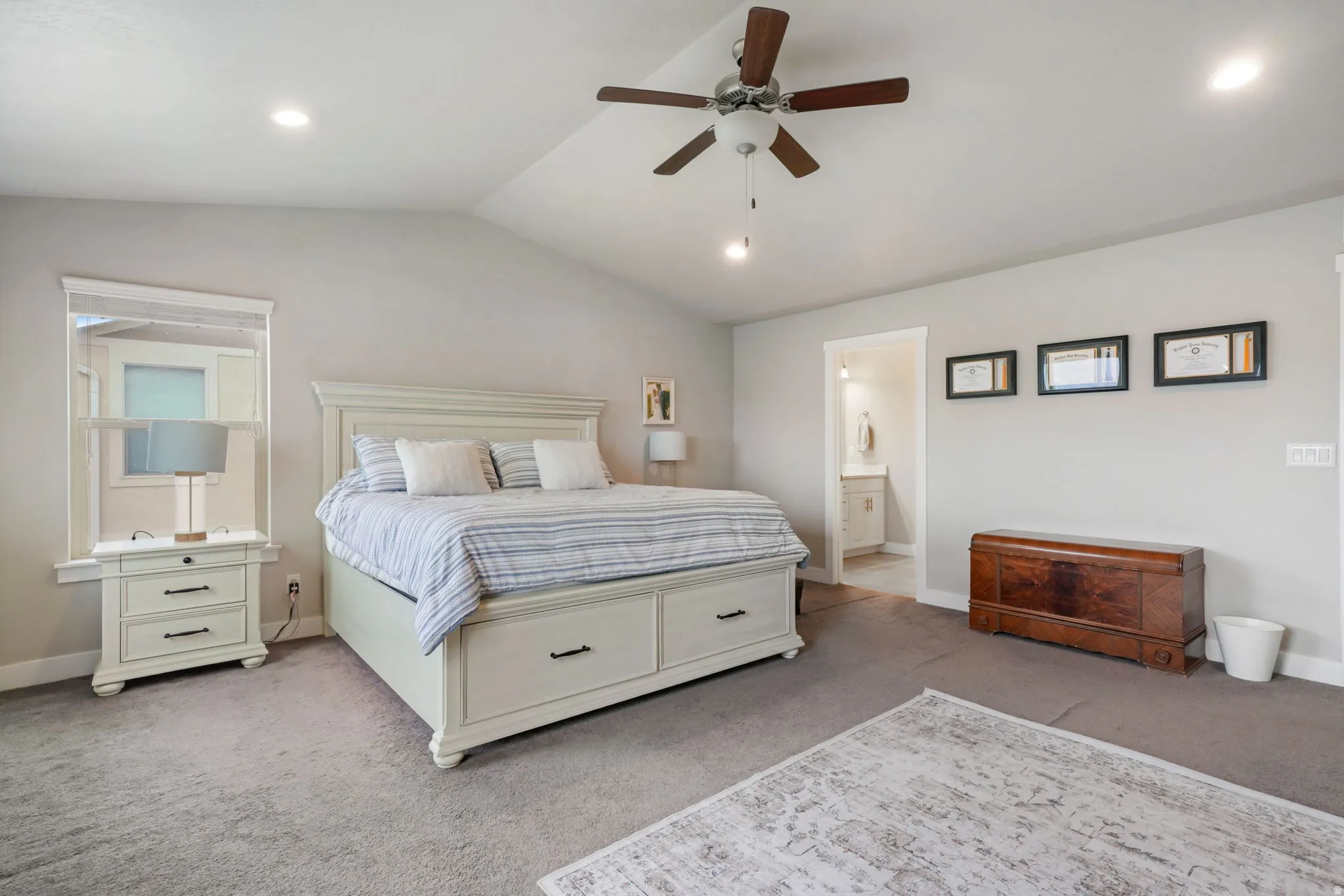 Carpeted bedroom with a ceiling fan and recessed lighting