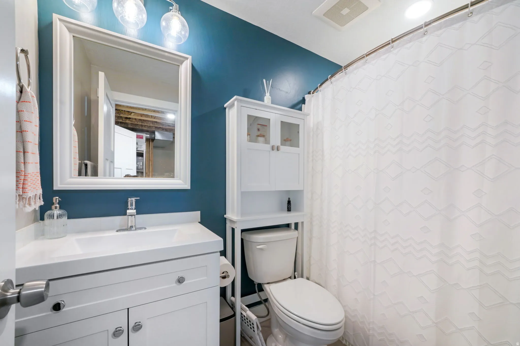 Full bathroom with vanity and a shower with shower curtain