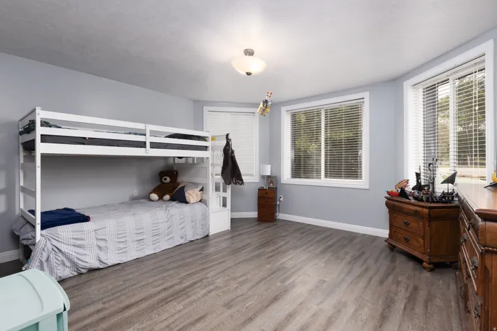 Bedroom featuring dark wood finished floors and baseboards