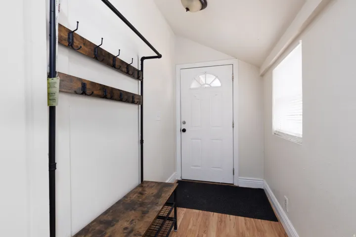 Entryway featuring vaulted ceiling and wood finished floors