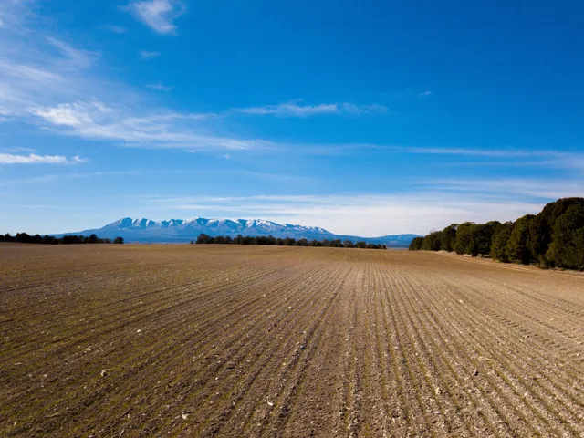 View of dirt / gravel road with a mountain view and a view of rural / pastoral area