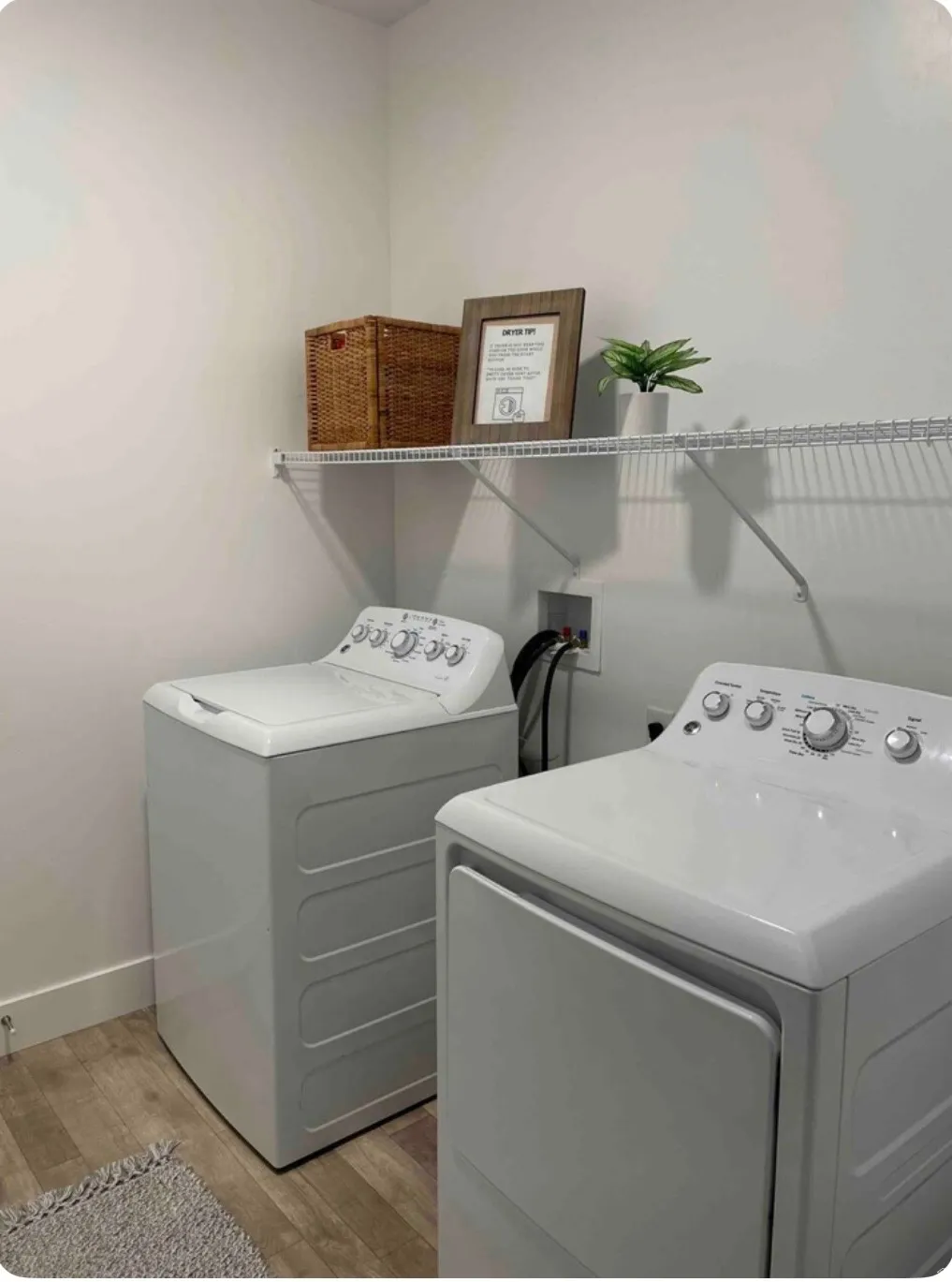 Laundry area with light wood-style flooring and washer and clothes dryer