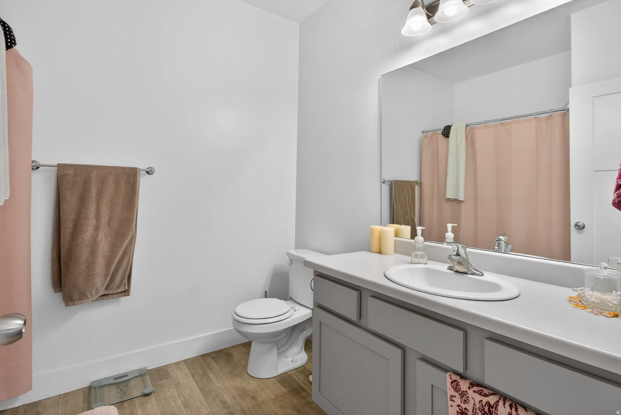 Bathroom featuring vanity, light wood-style flooring, and a shower with curtain