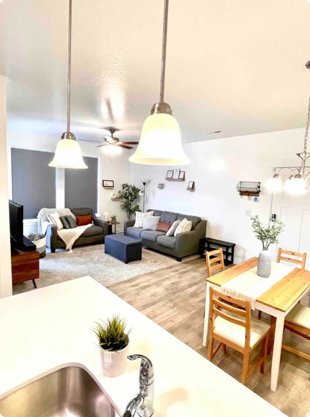 Living area featuring light wood-type flooring and ceiling fan