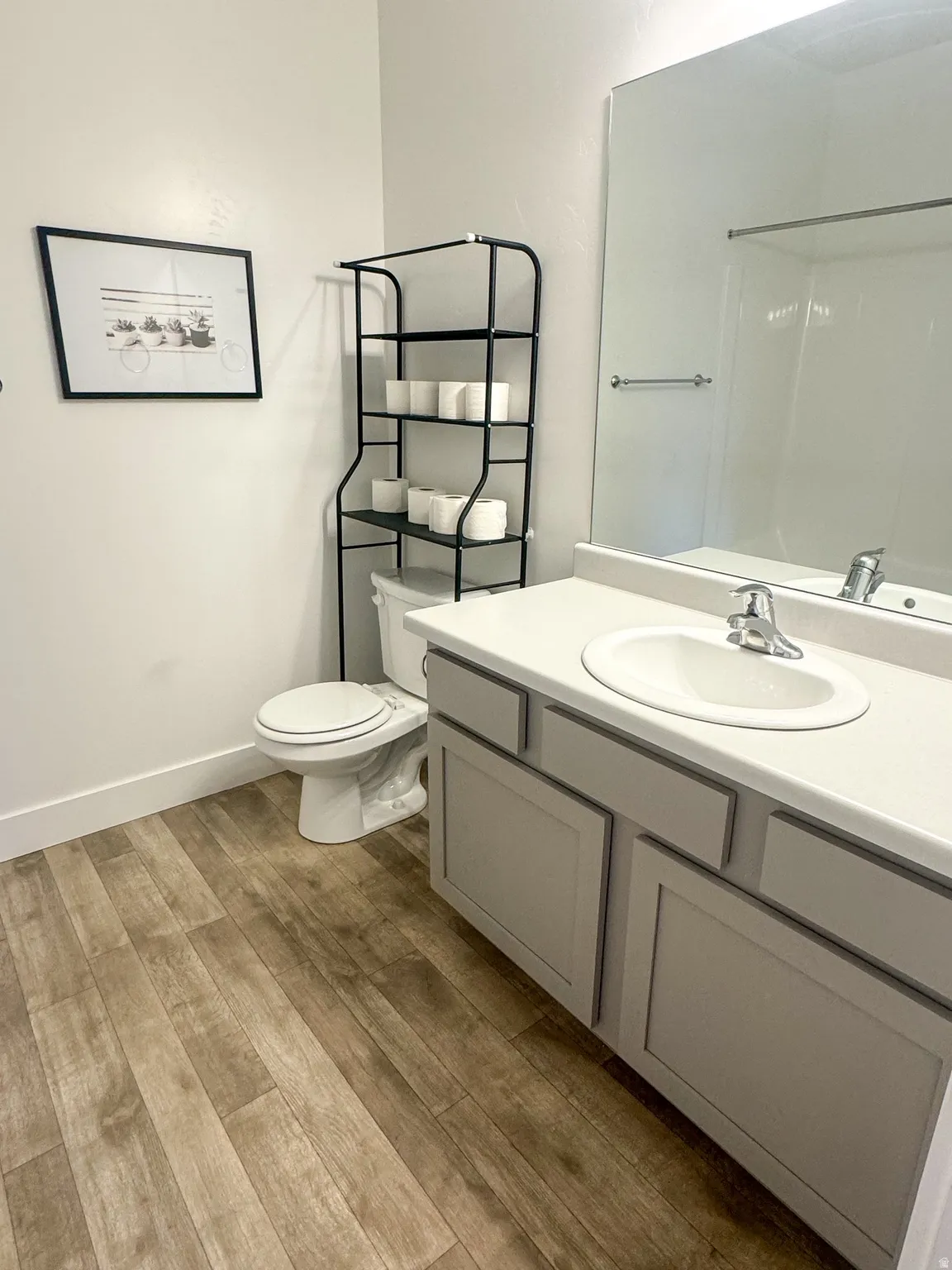Full bathroom featuring vanity and light wood-style flooring