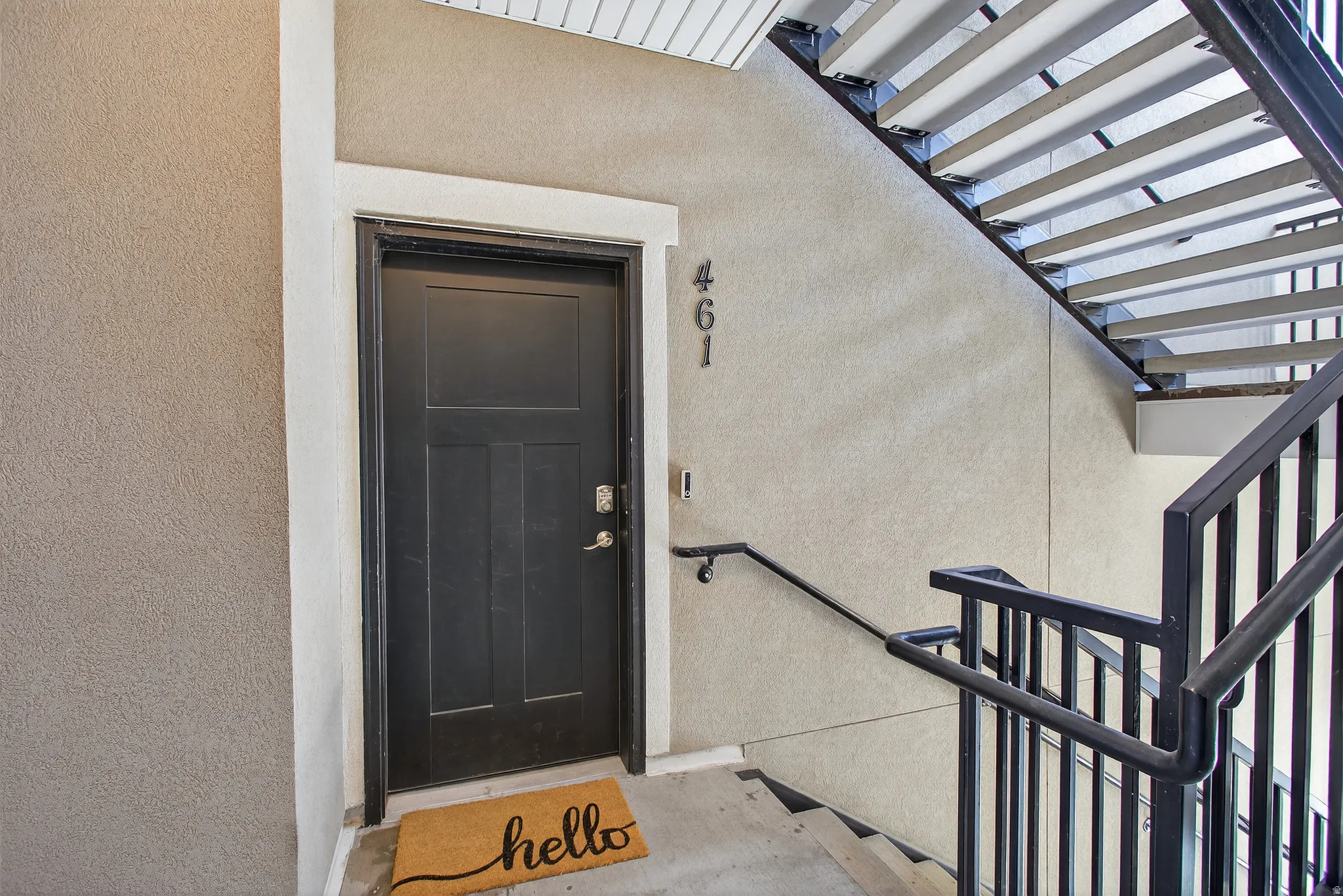 Doorway to property with stucco siding
