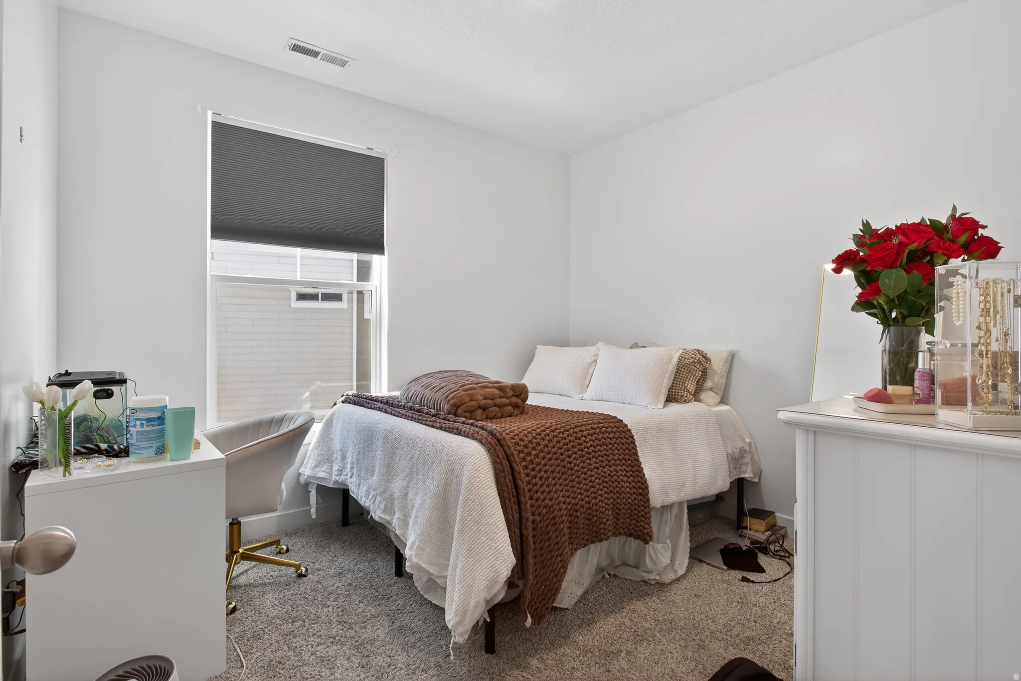 Bedroom with carpet and an office area