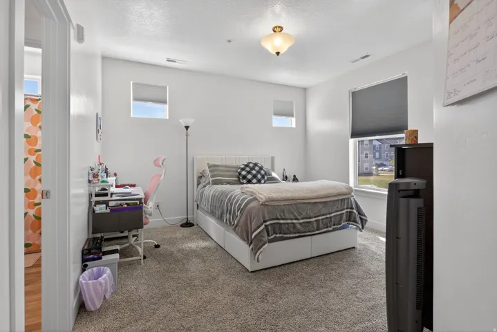 Primary bedroom featuring an office area and a textured ceiling