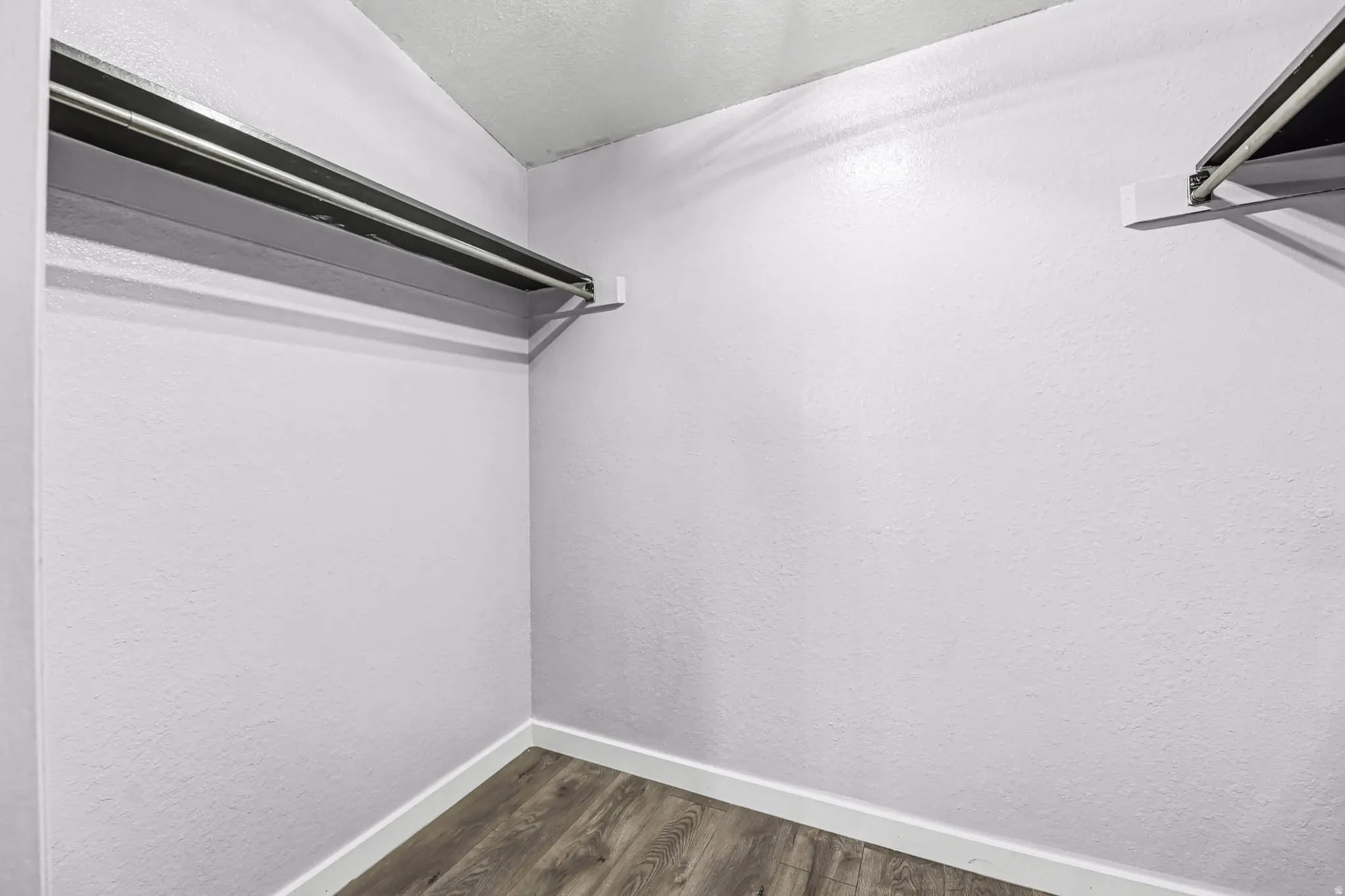Walk in closet featuring dark wood-style flooring