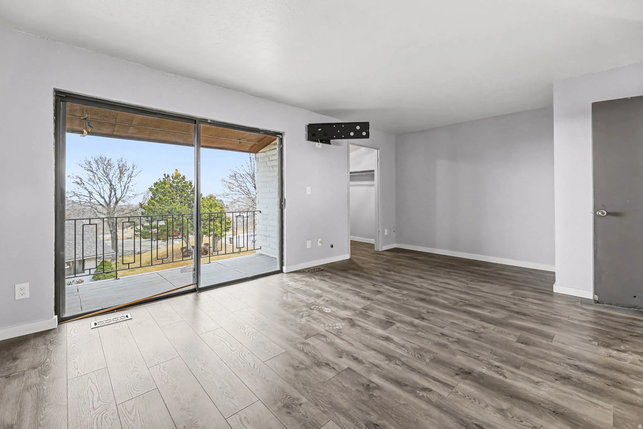 Unfurnished room with wood finished floors and baseboards