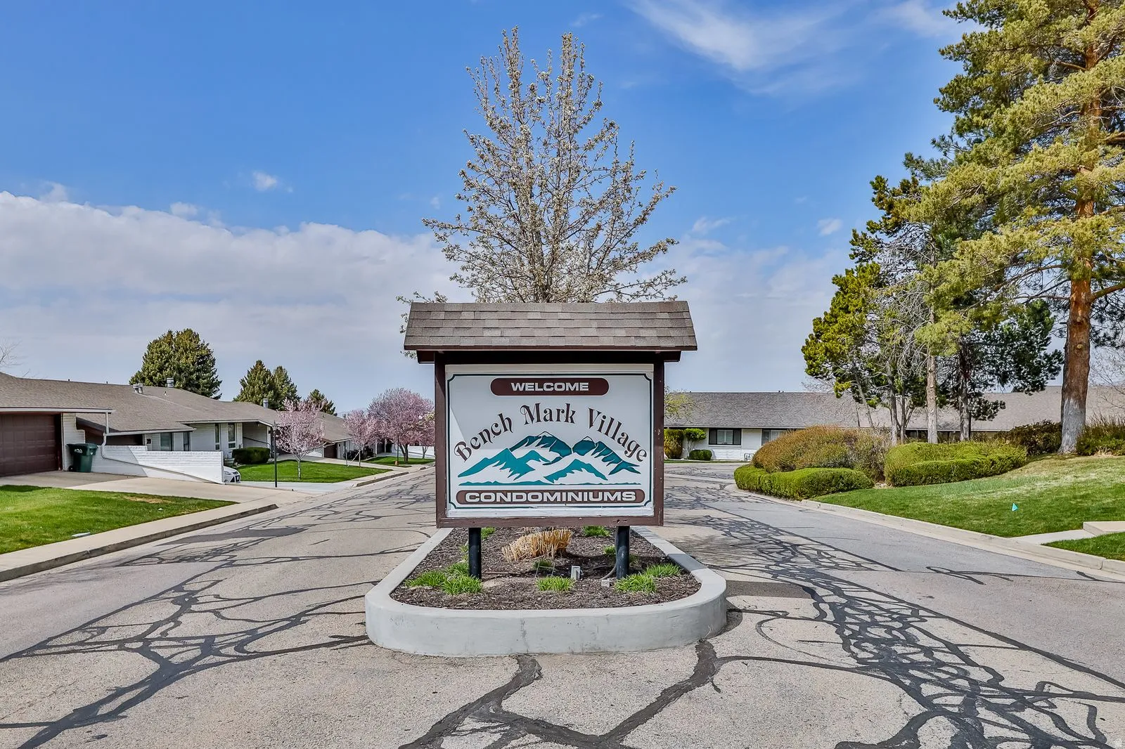Community / neighborhood sign with a lawn