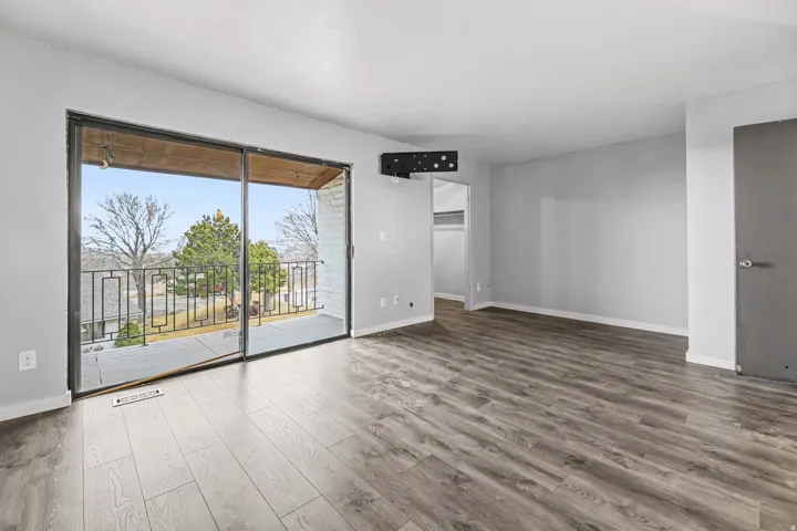 Unfurnished room with wood finished floors and baseboards