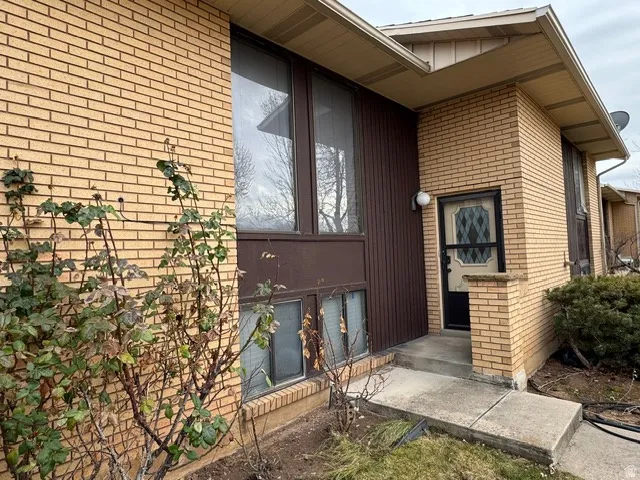 Entrance to property with brick siding