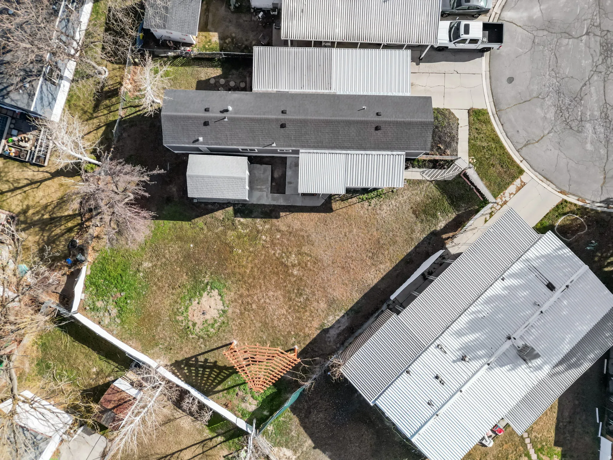 The yard is full of life; mature fruit trees, established plants, and space to garden, play, or simply unwind.