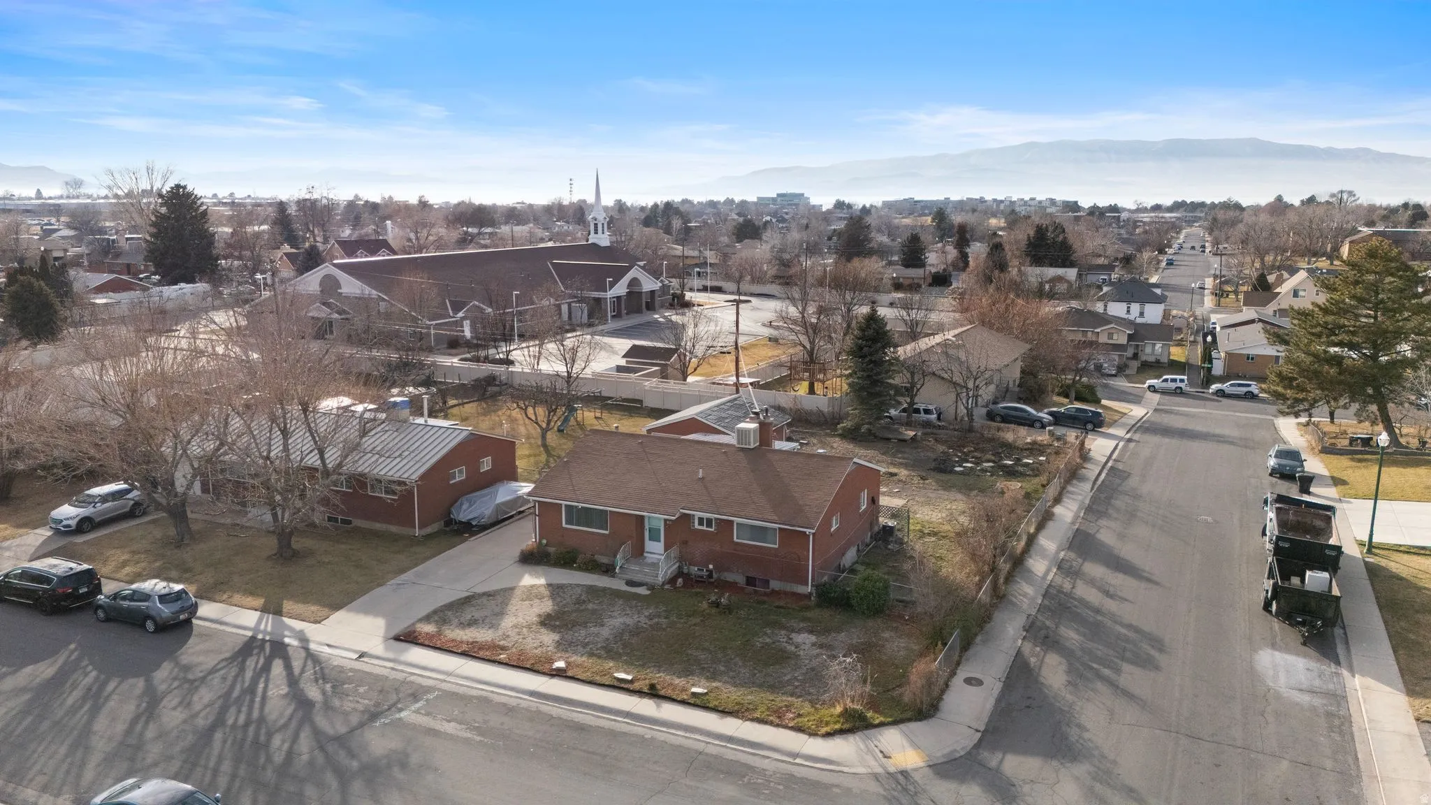 Aerial perspective of suburban area featuring a mountainous background