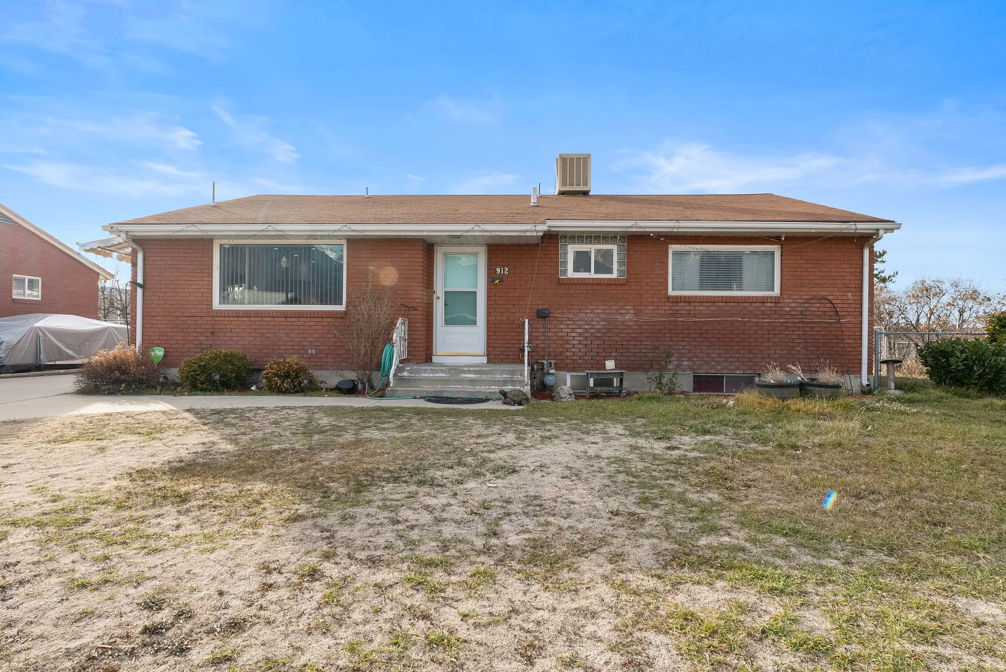 View of front of property with brick siding and a front lawn