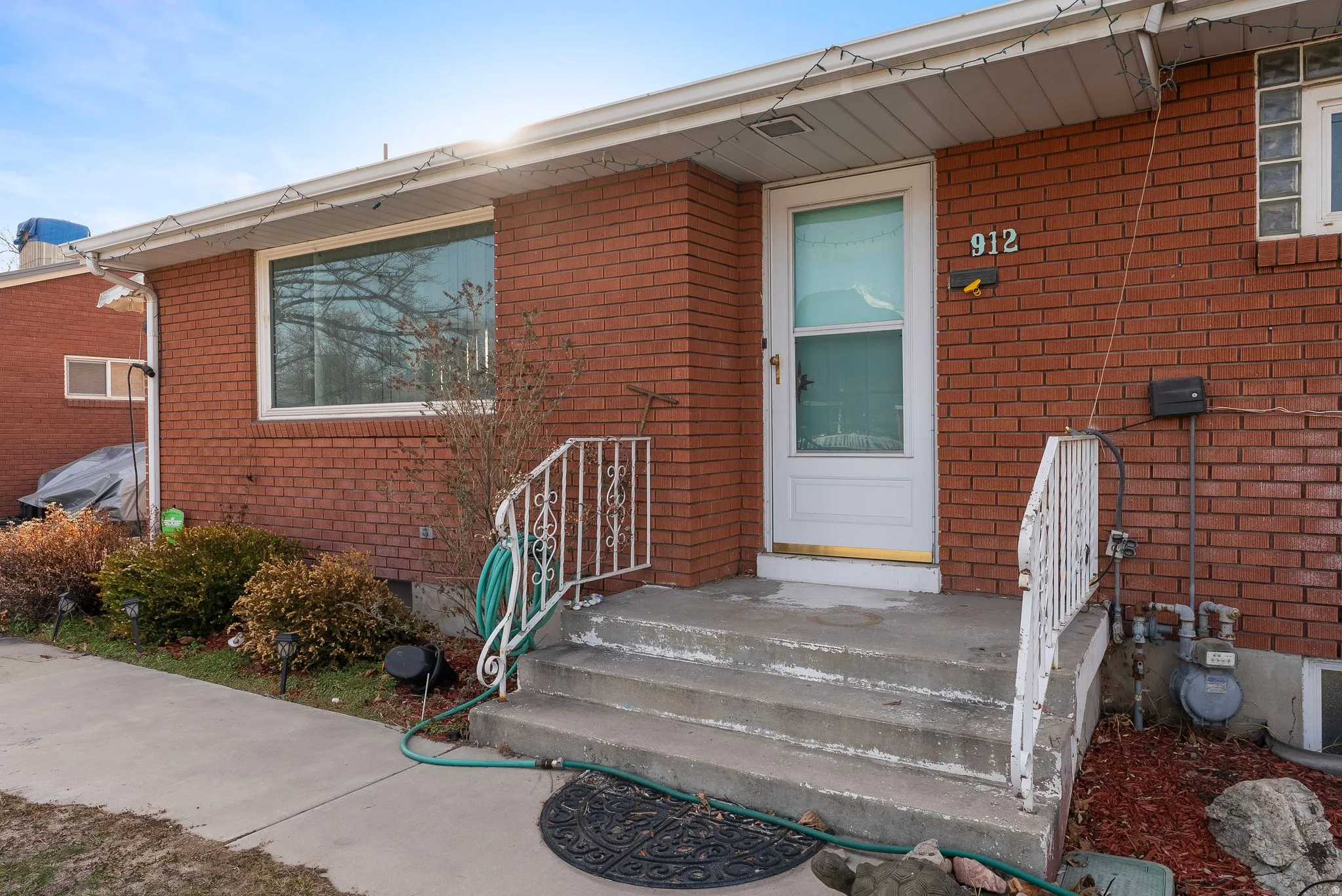 View of exterior entry featuring brick siding and crawl space