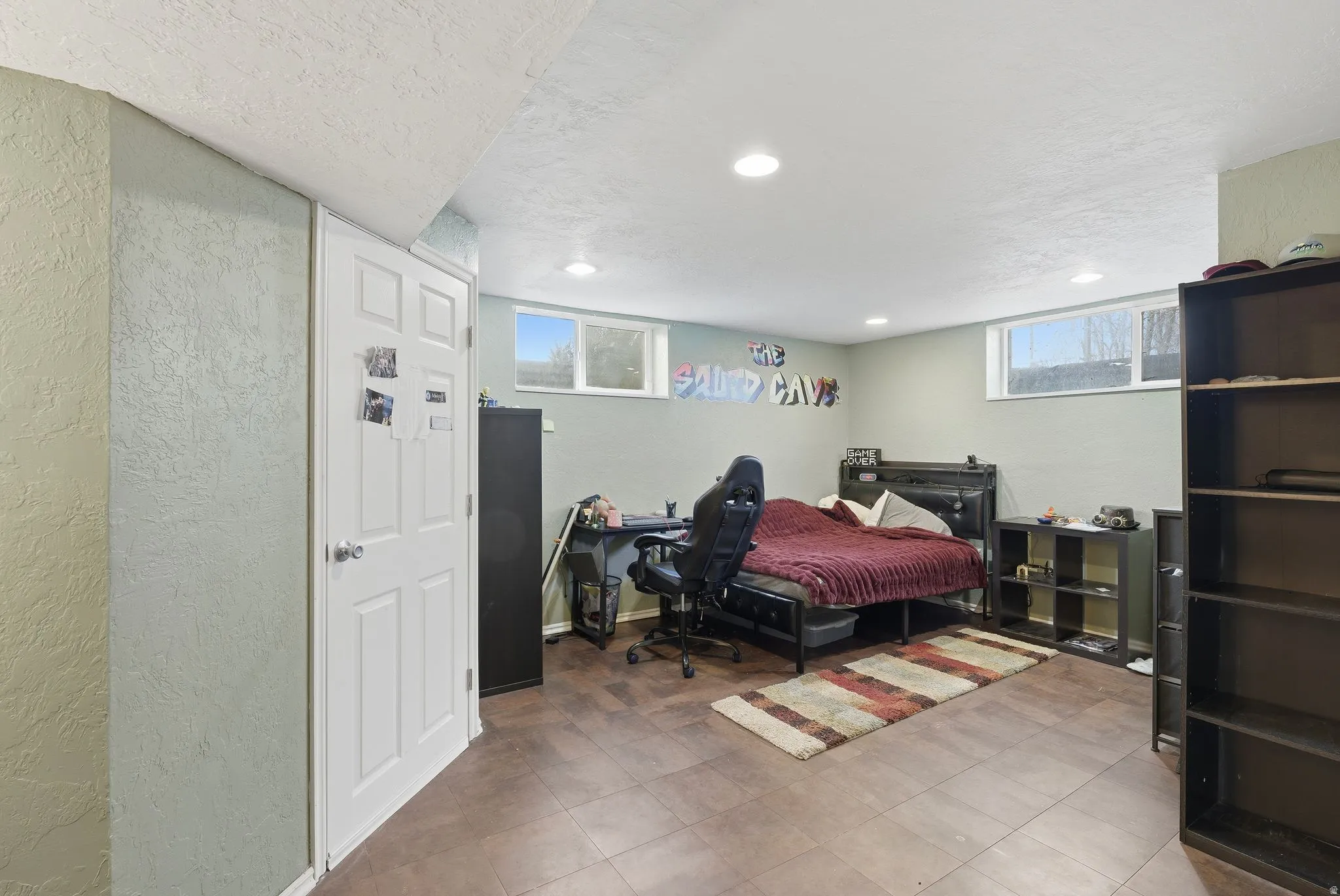 Bedroom with a textured wall and a textured ceiling