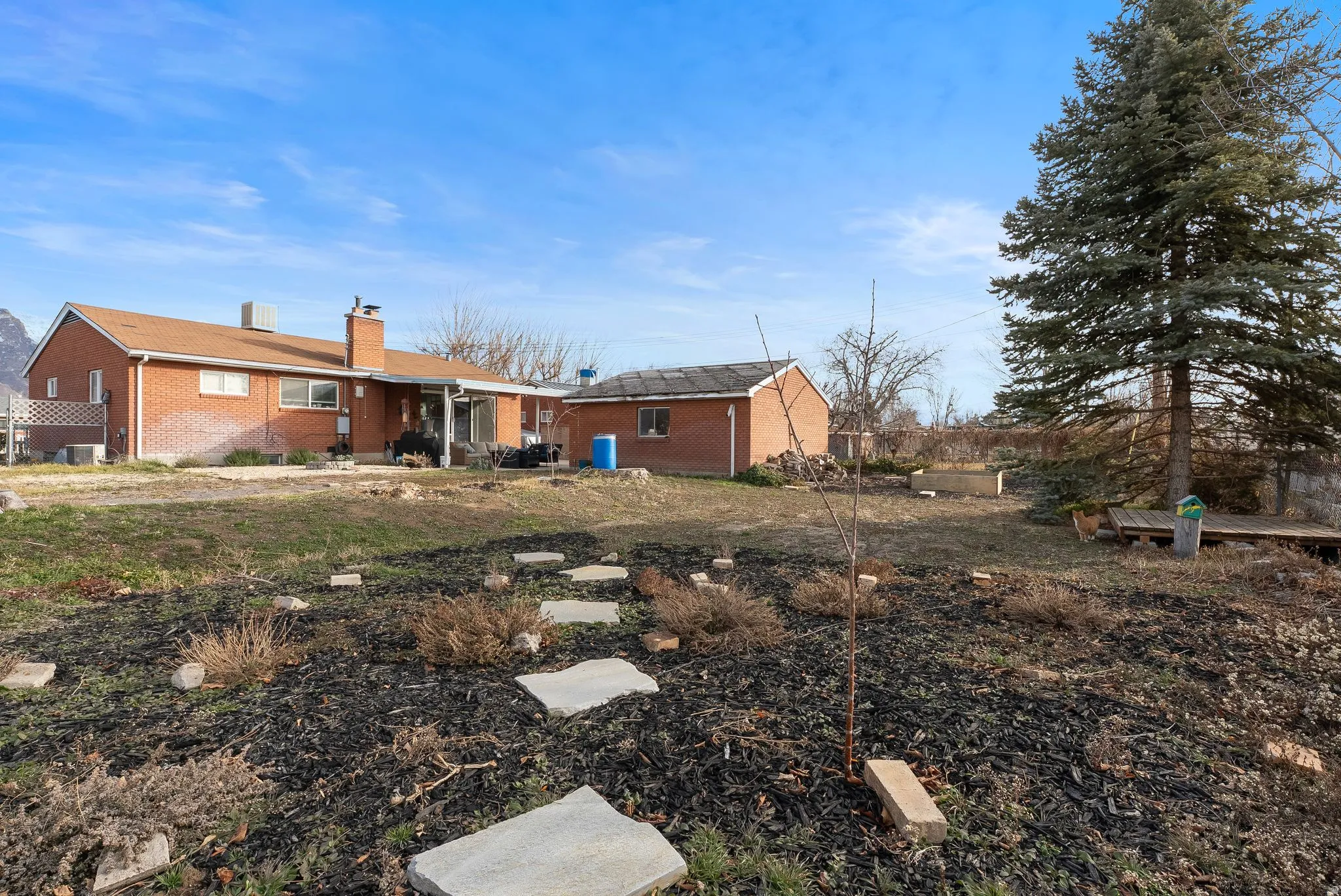 Back of property featuring a chimney, a patio, and brick siding