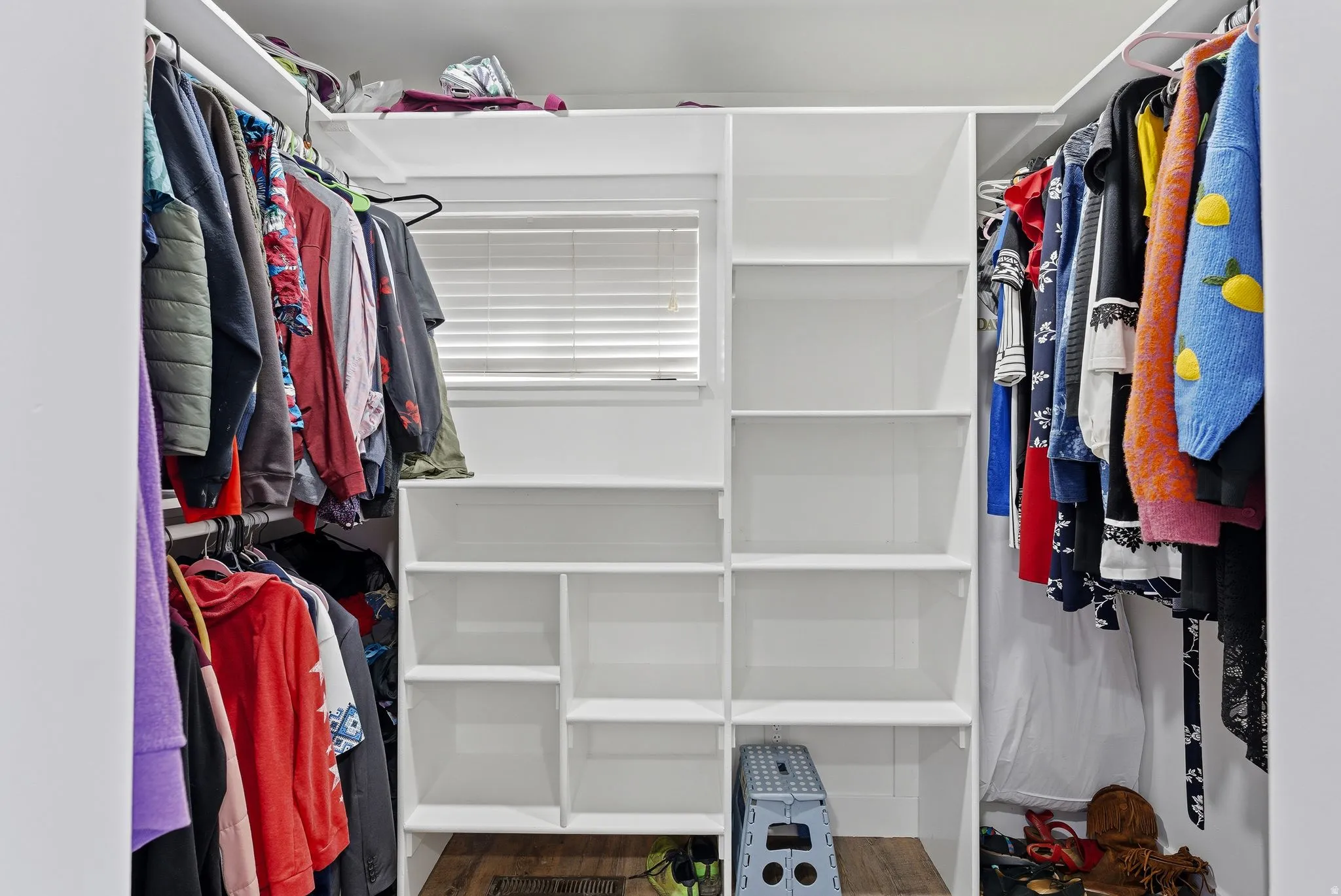 Walk in closet featuring dark wood-style floors