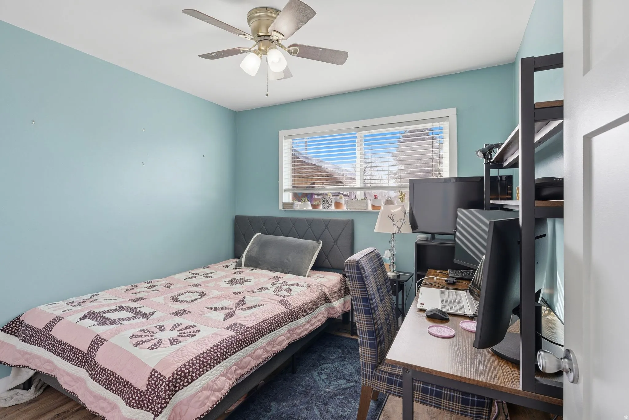 Bedroom featuring a desk, a ceiling fan, and wood finished floors