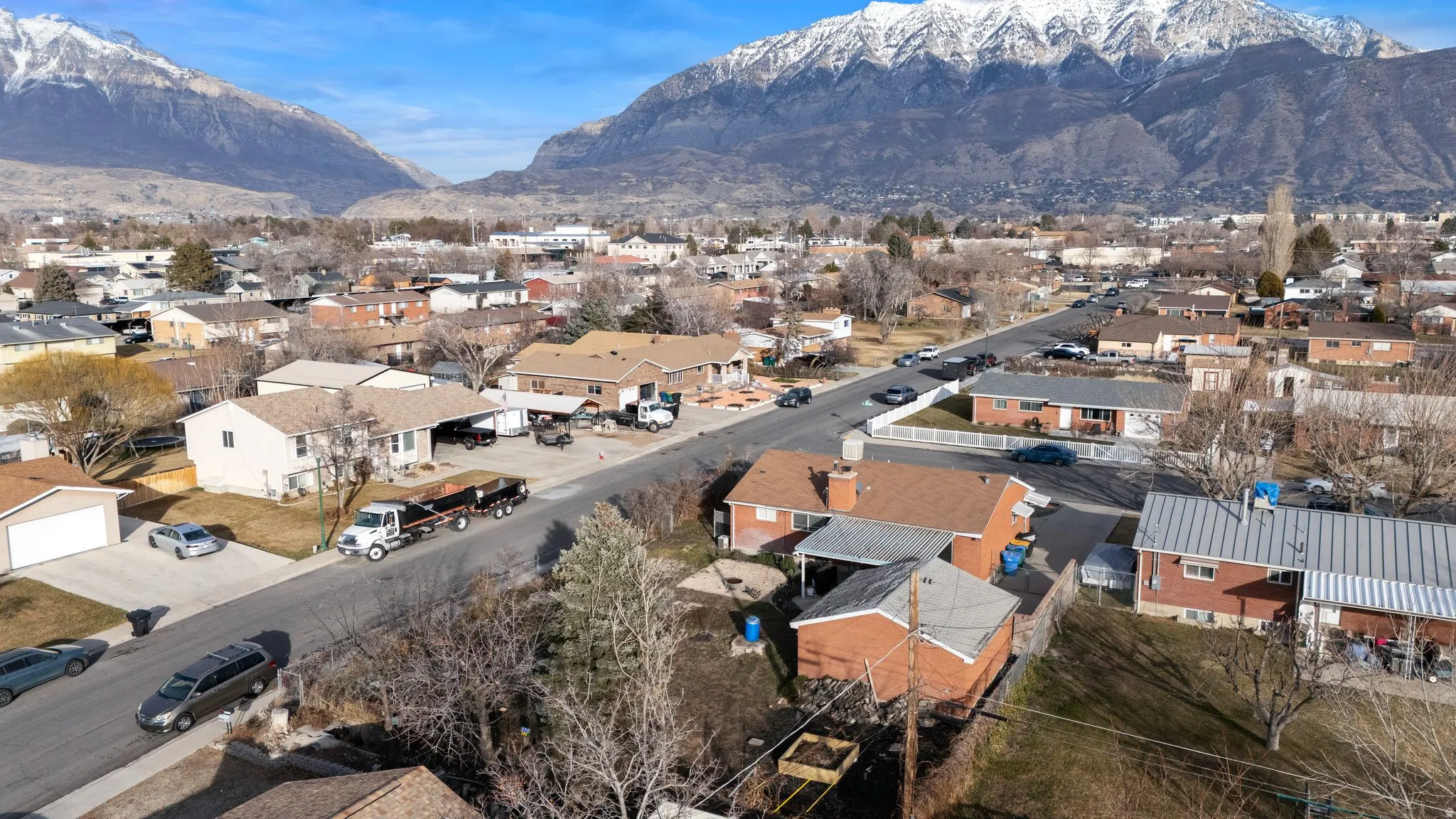 Aerial perspective of suburban area featuring a mountainous background