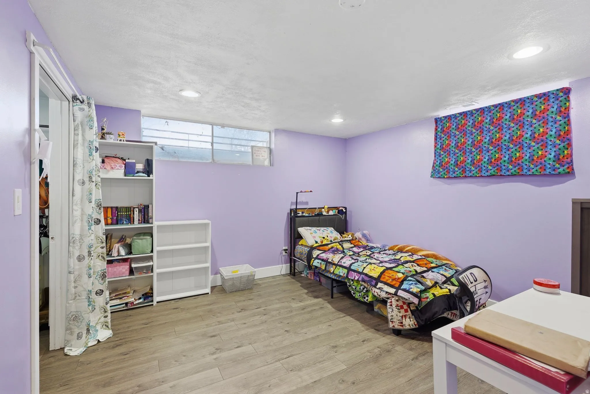 Bedroom with light wood-style flooring and recessed lighting