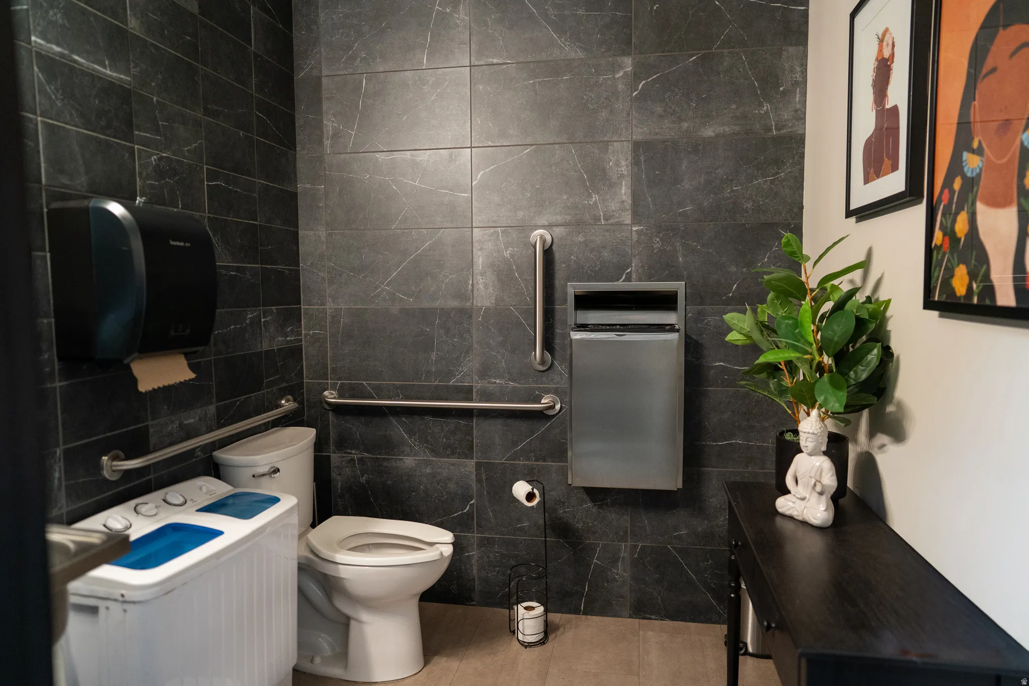 Bathroom featuring tile walls and toilet