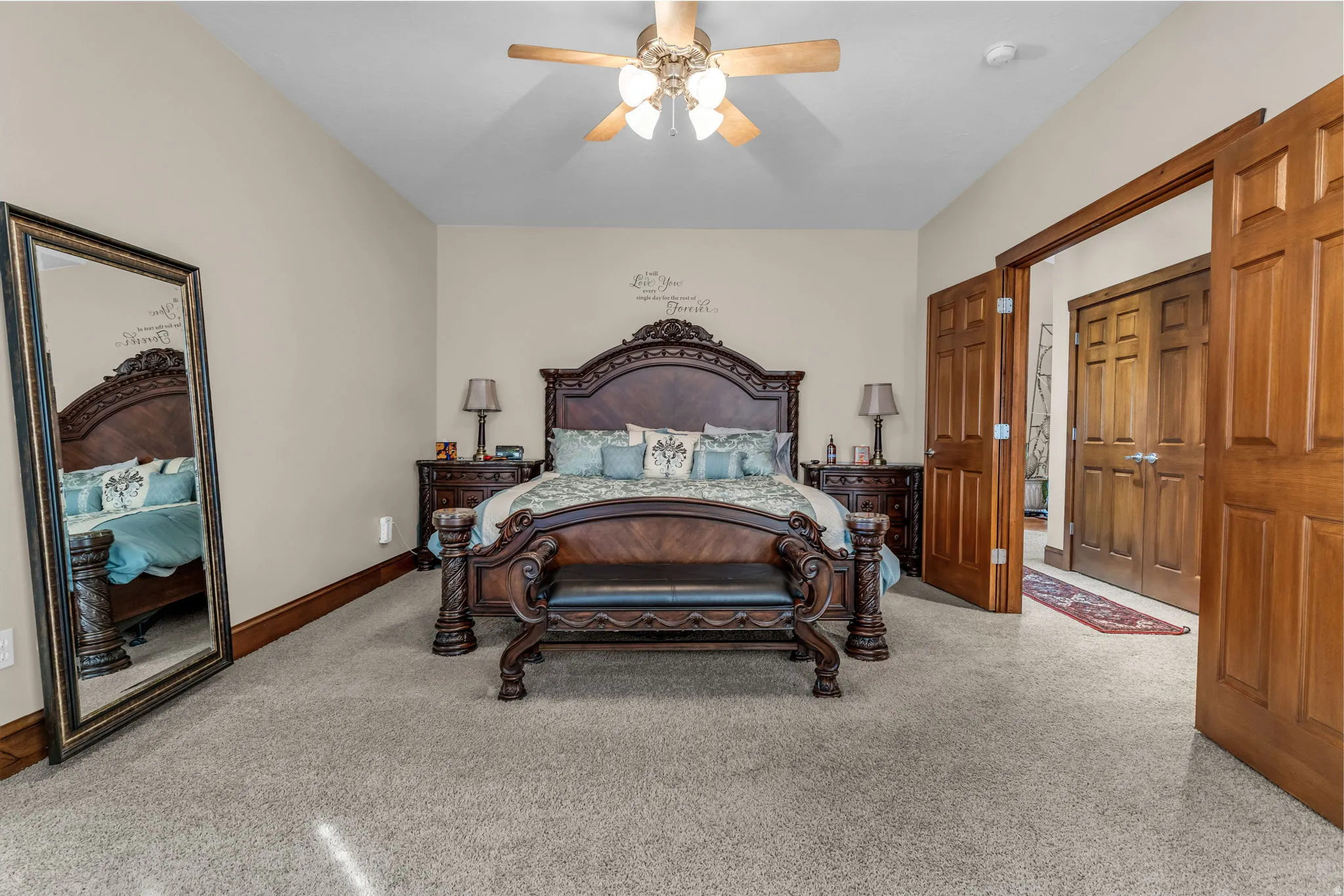 Carpeted bedroom with a ceiling fan and access to exterior