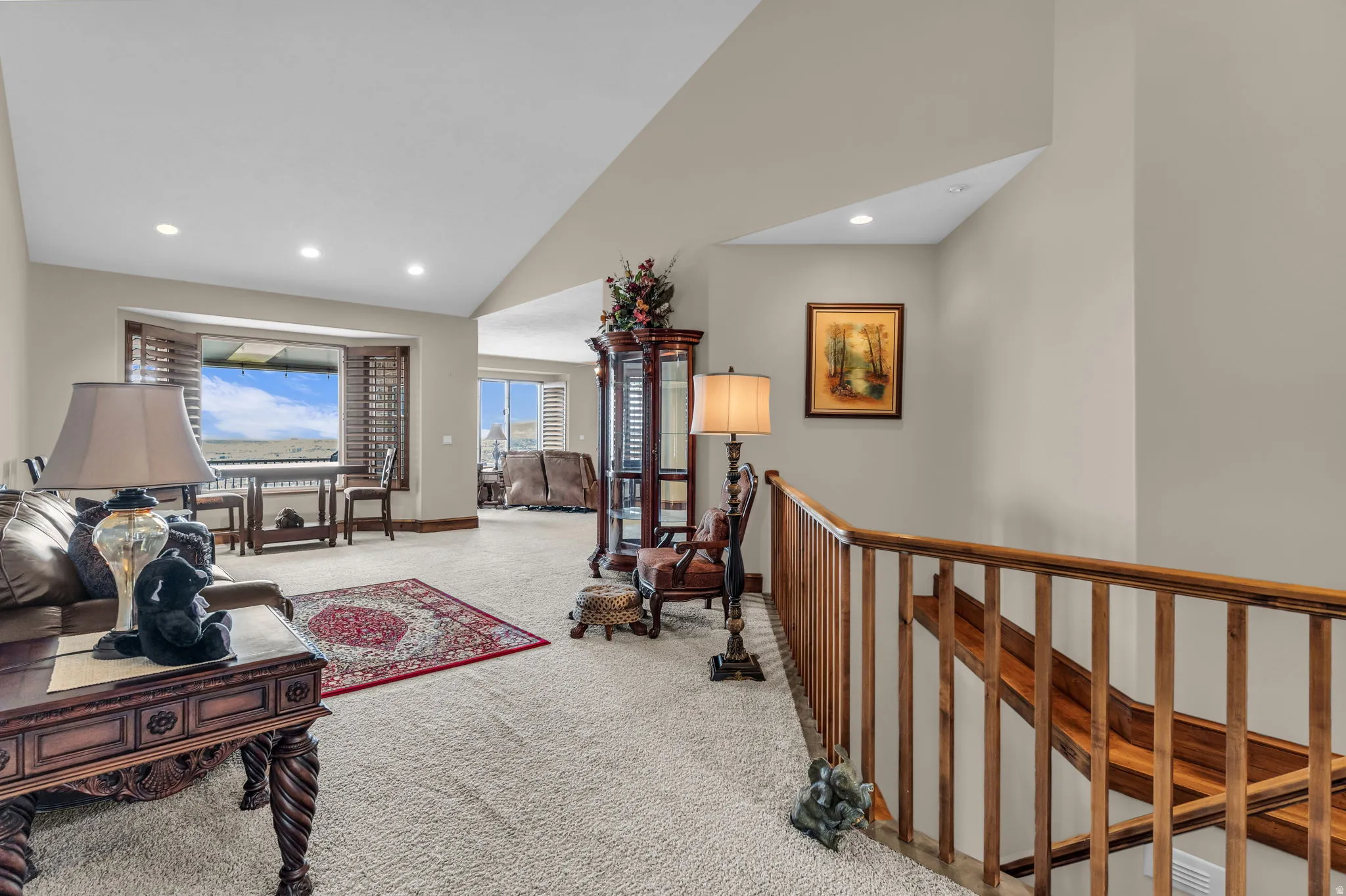 Living room with carpet, vaulted ceiling, and recessed lighting