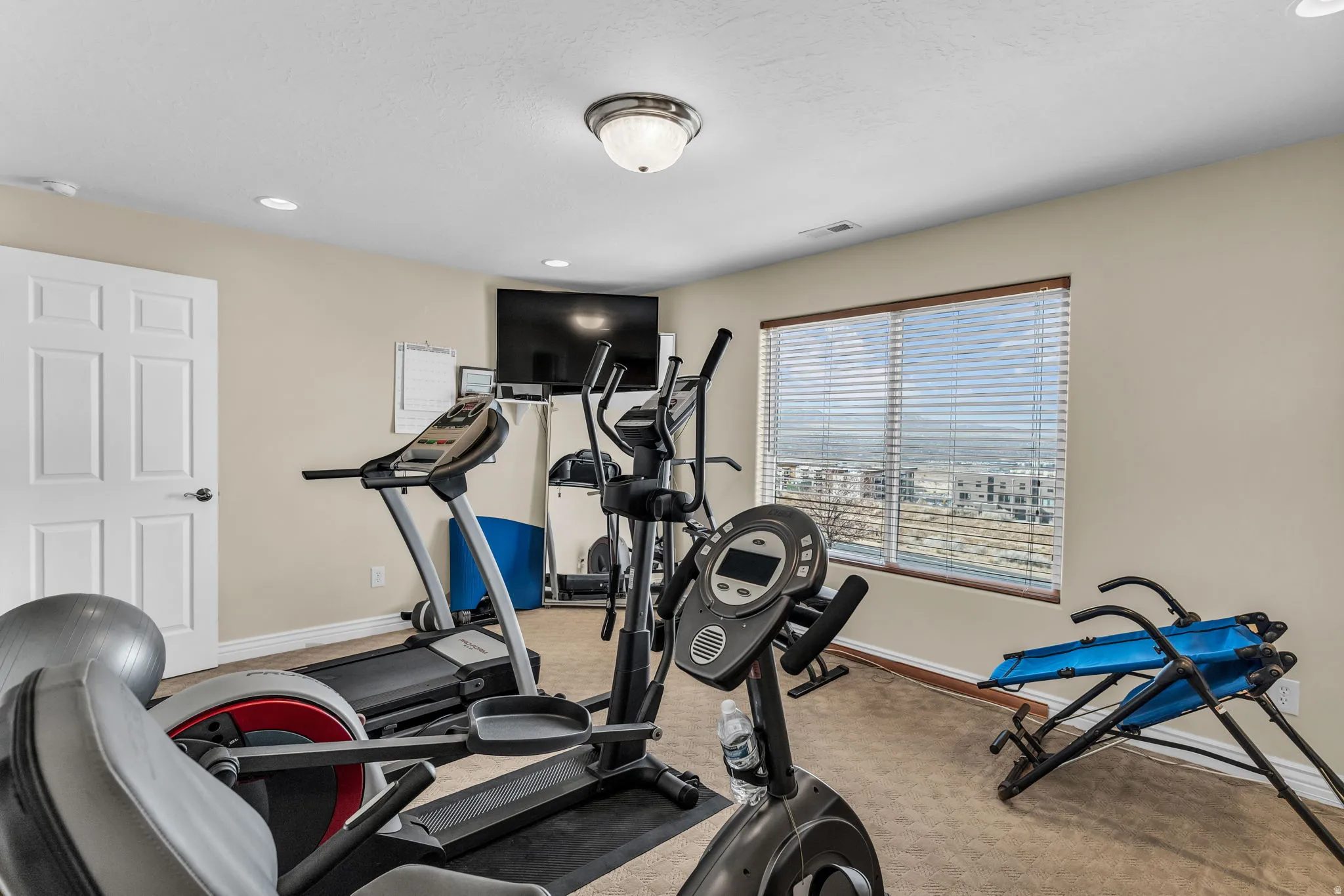 Exercise room featuring recessed lighting